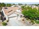 Aerial view of a single-story home with tile roof, solar panels, two-car garage, and desert landscaping at 1978 Kachina Mountain Dr, Henderson, NV 89012