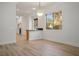 An open dining area features wood floors, modern lighting, and granite countertops at 1978 Kachina Mountain Dr, Henderson, NV 89012