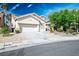 Inviting single-story home with a tile roof, two-car garage, desert landscaping, and palm tree at 1978 Kachina Mountain Dr, Henderson, NV 89012