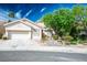 Charming single-story home featuring stucco exterior, tile roof, and well-manicured desert landscaping at 1978 Kachina Mountain Dr, Henderson, NV 89012