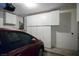Garage with overhead storage and a parked car at 1978 Kachina Mountain Dr, Henderson, NV 89012