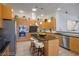 A modern kitchen with an island, stainless steel appliances, and custom wood cabinets at 1978 Kachina Mountain Dr, Henderson, NV 89012