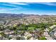 Elevated aerial view of a community with lush landscaping, mountain views, and mature trees at 1978 Kachina Mountain Dr, Henderson, NV 89012