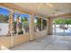 Enclosed outdoor patio featuring ceiling fans, neutral walls, and views of the lush landscaping at 1978 Kachina Mountain Dr, Henderson, NV 89012