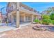 Inviting backyard with a covered patio, an outdoor fire pit, a spiral staircase, and desert landscaping at 201 Palmarosa St, Henderson, NV 89015