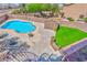An aerial view of a backyard with a kidney-shaped pool, green lawn, and storage shed at 201 Palmarosa St, Henderson, NV 89015