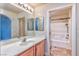 Bathroom featuring a vanity, a large mirror, and a tub shower combination at 201 Palmarosa St, Henderson, NV 89015