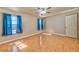 Bedroom with hardwood floors, ceiling fan, windows, and access to the rest of the house at 201 Palmarosa St, Henderson, NV 89015