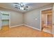 Neutral bedroom featuring wood-look floors, ceiling fan, and a doorway leading to a closet at 201 Palmarosa St, Henderson, NV 89015