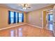 Bright bedroom with hardwood floors, neutral walls, and natural light from multiple windows at 201 Palmarosa St, Henderson, NV 89015
