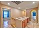 Hallway with cabinets and countertops, arched entryway, and access to other rooms at 201 Palmarosa St, Henderson, NV 89015