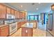 Traditional kitchen with wood cabinets, a breakfast bar, and modern appliances at 201 Palmarosa St, Henderson, NV 89015