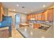 A spacious kitchen with wood cabinets, stainless steel appliances, and a large countertop area at 201 Palmarosa St, Henderson, NV 89015