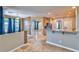 A spacious living room with tile floors, neutral walls, and arched doorways to other rooms at 201 Palmarosa St, Henderson, NV 89015