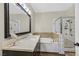 Bright bathroom featuring a soaking tub, a separate shower, and a large vanity mirror at 2050 W Warm Springs Rd # 823, Henderson, NV 89014