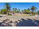 Community entrance with a water fountain feature, lush palm trees, and well-maintained landscaping at 2050 W Warm Springs Rd # 823, Henderson, NV 89014