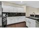 Gourmet kitchen with white cabinetry, stainless steel appliances, and granite countertops at 2050 W Warm Springs Rd # 823, Henderson, NV 89014