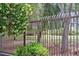 Scenic view of the community lake through an iron fence with mature trees and landscaping at 2050 W Warm Springs Rd # 823, Henderson, NV 89014