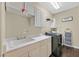 Bright laundry room with a utility sink, cabinets, and modern washer and dryer at 2050 W Warm Springs Rd # 823, Henderson, NV 89014