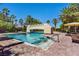 Resort-style pool area with a bridge, palm trees, lounge chairs, and umbrellas for a relaxing experience at 2050 W Warm Springs Rd # 823, Henderson, NV 89014