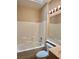 Clean bathroom with a combined shower and tub, tile surround, and vanity with lighting at 2138 Grand Traverse St, Henderson, NV 89052