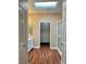 Bright bathroom with a skylight, wood-look flooring, and a walk-in closet visible through an open doorway at 2138 Grand Traverse St, Henderson, NV 89052