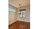 Bright dining room with hardwood floors, chandelier, and window with blinds at 2138 Grand Traverse St, Henderson, NV 89052