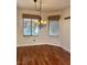 Cozy dining area featuring hardwood floors, chandelier, and dual windows at 2138 Grand Traverse St, Henderson, NV 89052