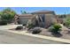 Single story home with desert landscape, two car garage, and inviting curbside appeal at 2138 Grand Traverse St, Henderson, NV 89052