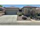 Charming single story home boasts desert landscaping, a two-car garage, and covered entry at 2138 Grand Traverse St, Henderson, NV 89052