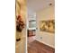 Hallway leading to kitchen, with hardwood floors, decorative painting, and recessed lighting at 2138 Grand Traverse St, Henderson, NV 89052