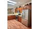 Bright kitchen featuring stainless steel appliances, tile countertops, and a skylight at 2138 Grand Traverse St, Henderson, NV 89052