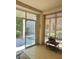 Sunroom with tile floors, bright windows with blinds, and a sliding door to the outside patio at 2138 Grand Traverse St, Henderson, NV 89052
