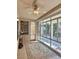 Cozy sunroom featuring built-in bookshelves, ceiling fan, and an area rug at 2138 Grand Traverse St, Henderson, NV 89052