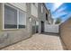 Backyard patio with pavers, modern exterior, and sliding glass doors and windows at 226 White Crest Peak Ave, Henderson, NV 89015