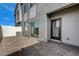 Outdoor patio with stylish pavers, modern exterior, and sliding glass door at 226 White Crest Peak Ave, Henderson, NV 89015
