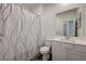 Clean bathroom with modern fixtures, tiled floors, and a shower with a decorative curtain at 226 White Crest Peak Ave, Henderson, NV 89015