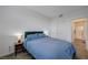Inviting bedroom with a full-sized bed, closet, and view of the bathroom at 226 White Crest Peak Ave, Henderson, NV 89015