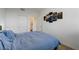 Cozy bedroom with a full-sized bed, closet, and artwork hanging on the wall at 226 White Crest Peak Ave, Henderson, NV 89015