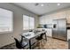 Cozy kitchen with seating for four, stainless appliances, and views of the surrounding neighborhood at 226 White Crest Peak Ave, Henderson, NV 89015