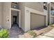 Modern townhouse entrance featuring a walkway leading to the front door and an attached garage at 226 White Crest Peak Ave, Henderson, NV 89015