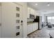 Compact kitchen next to a living area, boasting modern appliances and tile flooring at 226 White Crest Peak Ave, Henderson, NV 89015