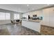 Well-lit kitchen featuring stainless steel appliances, a spacious island, and white cabinetry at 226 White Crest Peak Ave, Henderson, NV 89015