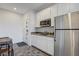 Eat-in kitchen with stainless steel fridge, breakfast table, and door to living space at 226 White Crest Peak Ave, Henderson, NV 89015