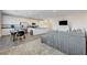 Bright living room features an open-concept design that connects to a modern kitchen and dining area at 226 White Crest Peak Ave, Henderson, NV 89015