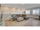 Upstairs living room area features neutral paint, large windows and an inviting sectional sofa at 226 White Crest Peak Ave, Henderson, NV 89015