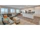 Open living space with modern kitchen, comfortable seating, and natural light from the large windows at 226 White Crest Peak Ave, Henderson, NV 89015