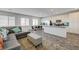 Open-concept living space with kitchen, dining area and comfortable seating with views from multiple windows at 226 White Crest Peak Ave, Henderson, NV 89015