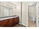 Bathroom featuring a dark wood vanity with granite countertop and a well-lit mirror at 2606 S Durango Dr # 245, Las Vegas, NV 89117