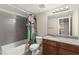 Full bathroom features tub, shower, single sink vanity, and stylish mirror at 2606 S Durango Dr # 245, Las Vegas, NV 89117